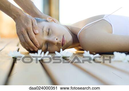 Woman having head massage, surrounded by flowers View Large Photo Image Stock Image - Woman having head massage, surrounded by flowers. Fotosearch