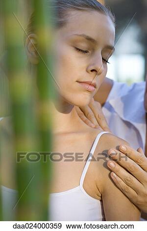 Stock Photo - Woman having shoulder massage. Fotosearch