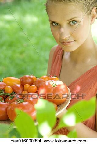 Woman holding bowl full of tomatoes View Large Photo Image Picture - Woman holding bowl full of tomatoes. Fotosearch