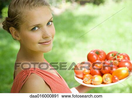 Woman holding bowl full of tomatoes View Large Photo Image Stock Image - Woman holding bowl full of tomatoes. Fotosearch