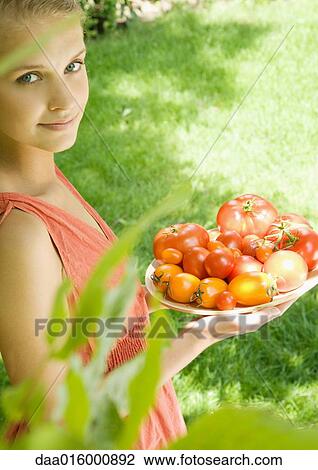 Woman holding bowl full of tomatoes View Large Photo Image Stock Image - Woman holding bowl full of tomatoes. Fotosearch
