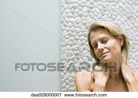 Woman holding neck, closing eyes, smiling View Large Photo Image Stock Photo - Woman holding neck, closing eyes, smiling. Fotosearch