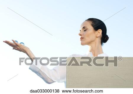 Woman holding out yin yang balls in palm of hand View Large Photo Image Stock Photo - Woman holding out yin yang balls in palm of hand. Fotosearch