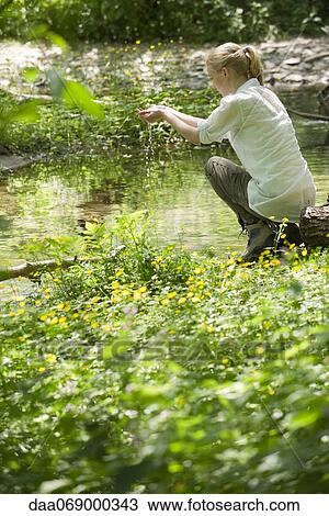 Stock Image - Woman holding water in cupped hands. Fotosearch