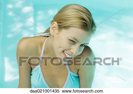 Stock Photography - Woman in bikini winking at camera, portrait. Fotosearch
