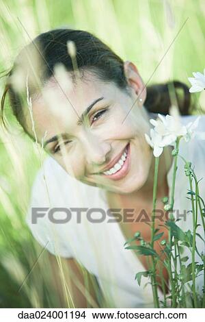 Woman in field, smiling at camera, portrait View Large Photo Image Picture - Woman in field, smiling at camera, portrait. Fotosearch