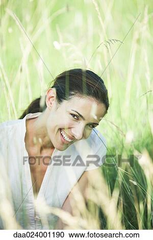 Woman in field, smiling at camera, portrait View Large Photo Image Stock Image - Woman in field, smiling at camera, portrait. Fotosearch