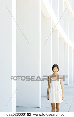 Woman in sundress standing outdoors, smiling at camera View Large Photo Image Stock Image - Woman in sundress standing outdoors, smiling at camera. Fotosearch