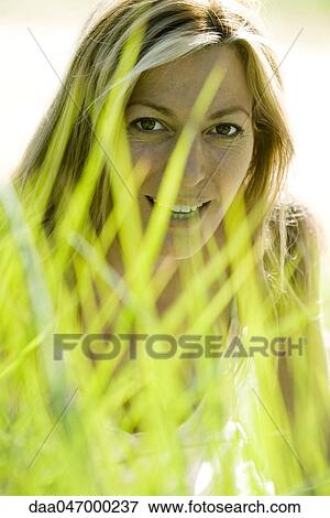 Woman in tall grass View Large Photo Image Stock Photo - Woman in tall grass. Fotosearch