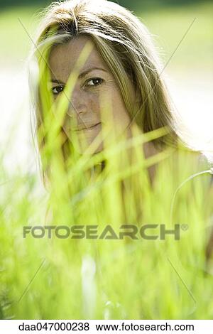 Woman in tall grass View Large Photo Image Stock Photo - Woman in tall grass. Fotosearch