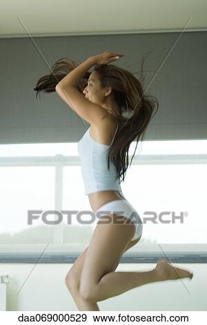 Woman in underwear jumping indoors View Large Photo Image Stock Photo - Woman in underwear jumping indoors. Fotosearch
