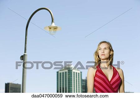 Woman in urban setting, looking away View Large Photo Image Stock Photo - Woman in urban setting, looking away. Fotosearch