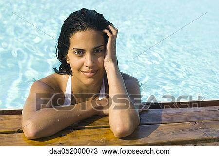 Woman in water resting at edge of swimming pool, portrait View Large Photo Image Stock Image - Woman in water resting at edge of swimming pool, portrait. Fotosearch