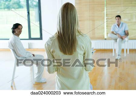 Woman leading group therapy session, rear view View Large Photo Image Stock Image - Woman leading group therapy session, rear view. Fotosearch