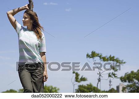 Woman listening to earphones outdoors View Large Photo Image Stock Image - Woman listening to earphones outdoors. Fotosearch