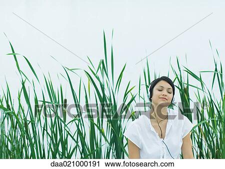 Woman listening to headphones, eyes closed View Large Photo Image Stock Image - Woman listening to headphones, eyes closed. Fotosearch
