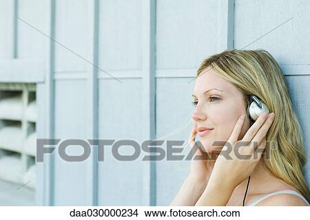 Woman listening to headphones View Large Photo Image Picture - Woman listening to headphones. Fotosearch