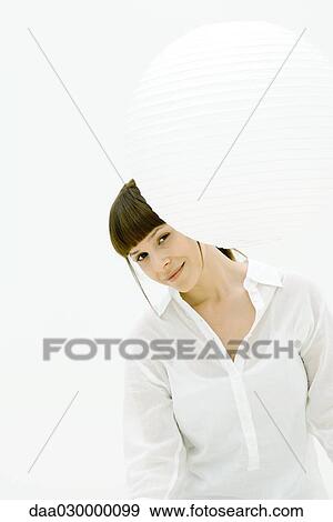 Woman looking around paper lantern, smiling at camera View Large Photo Image Stock Photo - Woman looking around paper lantern, smiling at camera. Fotosearch