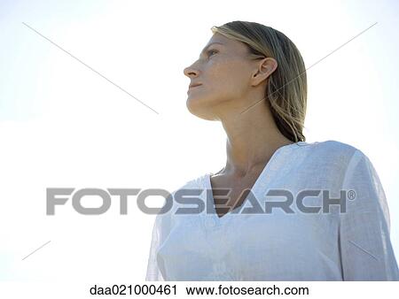 Woman, looking away, low angle view, portrait View Large Photo Image Stock Image - Woman, looking away, low angle view, portrait. Fotosearch