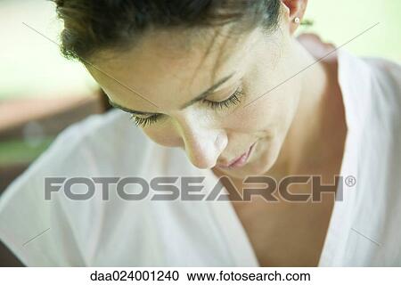 Stock Image - Woman looking down, cropped. Fotosearch