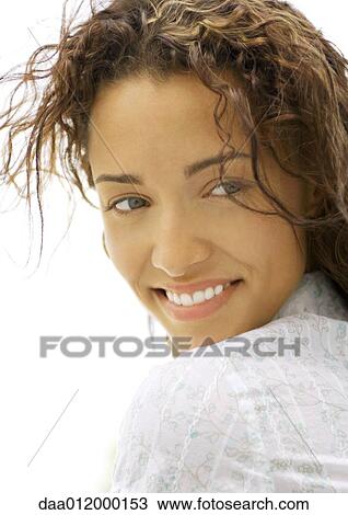 Woman looking over shoulder, smiling, close-up View Large Photo Image Stock Image - Woman looking over shoulder, smiling, close-up. Fotosearch