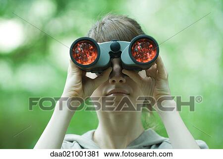 Stock Image - Woman looking through binoculars. Fotosearch