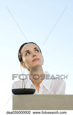 Woman looking up, incense in foreground View Large Photo Image Stock Image - Woman looking up, incense in foreground. Fotosearch