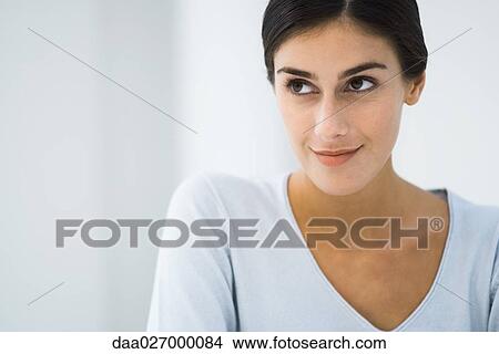 Woman looking up, smiling, head and shoulders, portrait View Large Photo Image Picture - Woman looking up, smiling, head and shoulders, portrait. Fotosearch