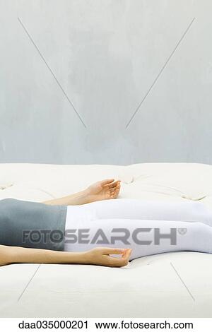 Woman lying on back on futon, palms turned upward, cropped view View Large Photo Image Stock Image - Woman lying on back on futon, palms turned upward, cropped view. Fotosearch