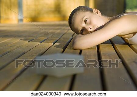 Woman lying on deck View Large Photo Image Stock Photo - Woman lying on deck. Fotosearch