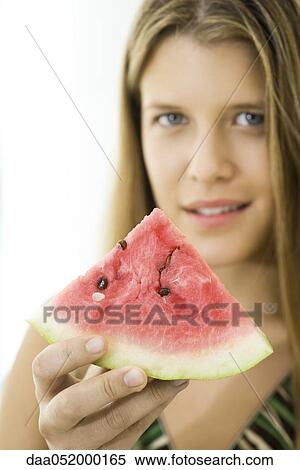Stock Photography - Woman offering slice of watermelon. Fotosearch