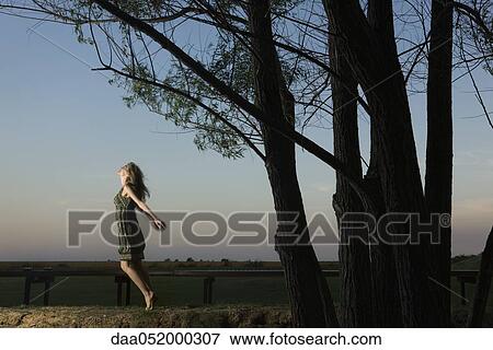 Woman on tiptoes, arms out, jumping View Large Photo Image Stock Photo - Woman on tiptoes, arms out, jumping. Fotosearch