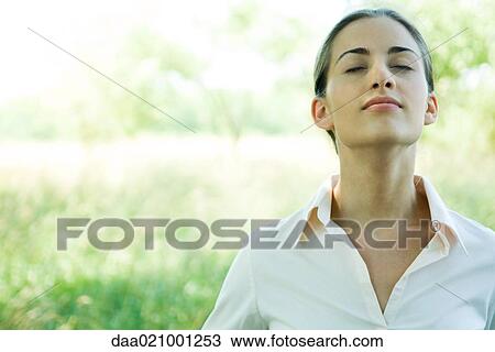 Woman outdoors, head and shoulders, head back and eyes closed View Large Photo Image Stock Image - Woman outdoors, head and shoulders, head back and eyes closed. Fotosearch
