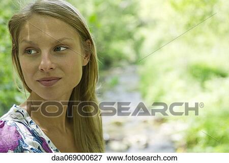 Woman outdoors, looking away in thought, portrait View Large Photo Image Stock Photo - Woman outdoors, looking away in thought, portrait. Fotosearch