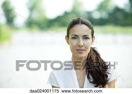 Woman outdoors, smiling at camera, head and shoulders View Large Photo Image Stock Photography - Woman outdoors, smiling at camera, head and shoulders. Fotosearch
