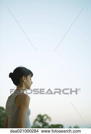 Woman outside with eyes closed at twilight View Large Photo Image Picture - Woman outside with eyes closed at twilight. Fotosearch