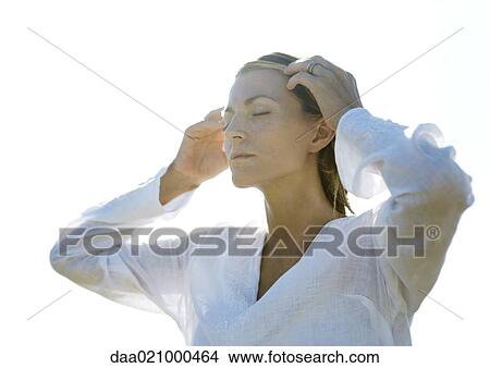 Woman pushing hair off face, eyes closed View Large Photo Image Picture - Woman pushing hair off face, eyes closed. Fotosearch