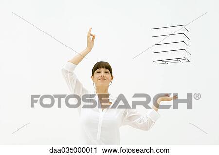 Woman raising arms, eyes closed, cube floating in midair View Large Photo Image Stock Image - Woman raising arms, eyes closed, cube floating in midair. Fotosearch