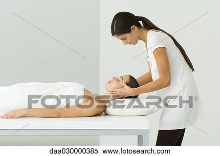 Woman receiving a head massage, side view View Large Photo Image Stock Photography - Woman receiving a head massage, side view. Fotosearch