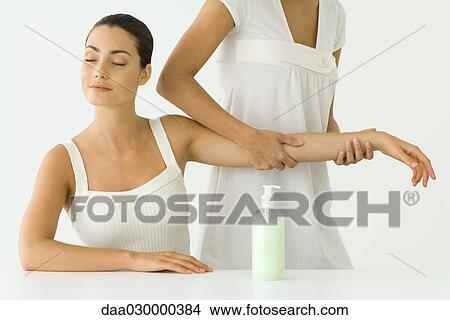 Woman receiving arm massage, eyes closed View Large Photo Image Picture - Woman receiving arm massage, eyes closed. Fotosearch