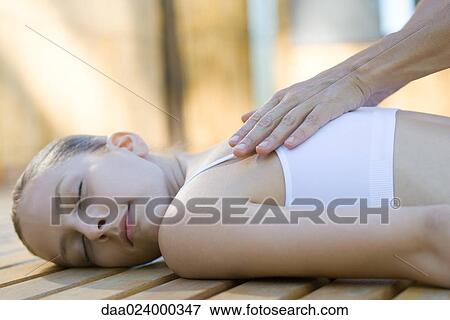 Woman receiving back massage View Large Photo Image Stock Photo - Woman receiving back massage. Fotosearch