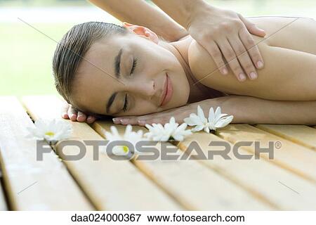Woman receiving back massage View Large Photo Image Stock Photo - Woman receiving back massage. Fotosearch