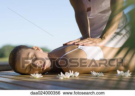 Woman receiving back massage View Large Photo Image Stock Photograph - Woman receiving back massage. Fotosearch