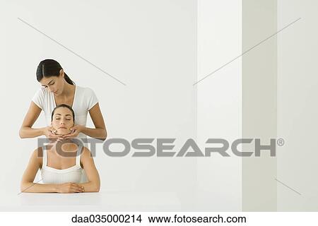 Woman receiving facial massage View Large Photo Image Picture - Woman receiving facial massage. Fotosearch