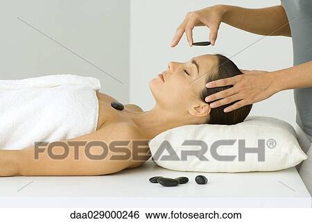 Woman receiving hot stone therapy, eyes closed View Large Photo Image Stock Photograph - Woman receiving hot stone therapy, eyes closed. Fotosearch