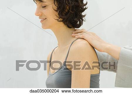 Woman receiving lower neck massage View Large Photo Image Picture - Woman receiving lower neck massage. Fotosearch