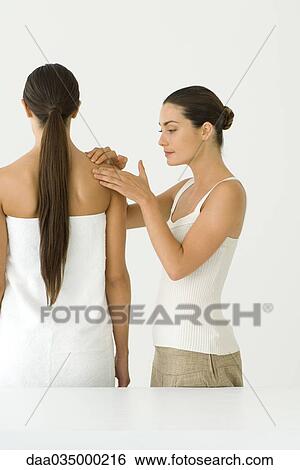 Stock Photograph - Woman receiving shoulder massage therapy. Fotosearch