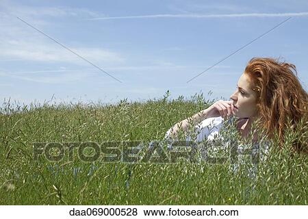 Woman relaxing in grass View Large Photo Image Stock Photo - Woman relaxing in grass. Fotosearch