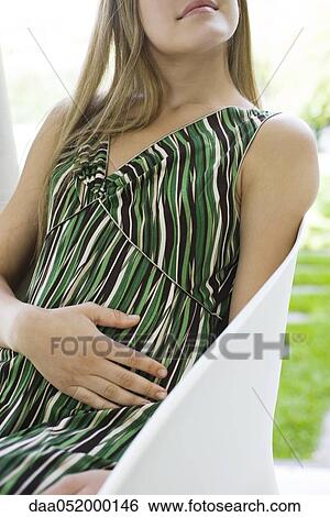 Stock Photograph - Woman relaxing outdoors, cropped. Fotosearch