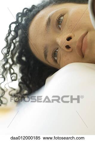 Stock Photography - Woman resting head, looking away, close-up. Fotosearch